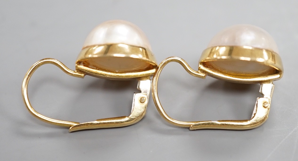 A modern pair of Italian 750 yellow metal and mabe pearl set earrings, diameter 11mm, gross weight 6.4 grams.
